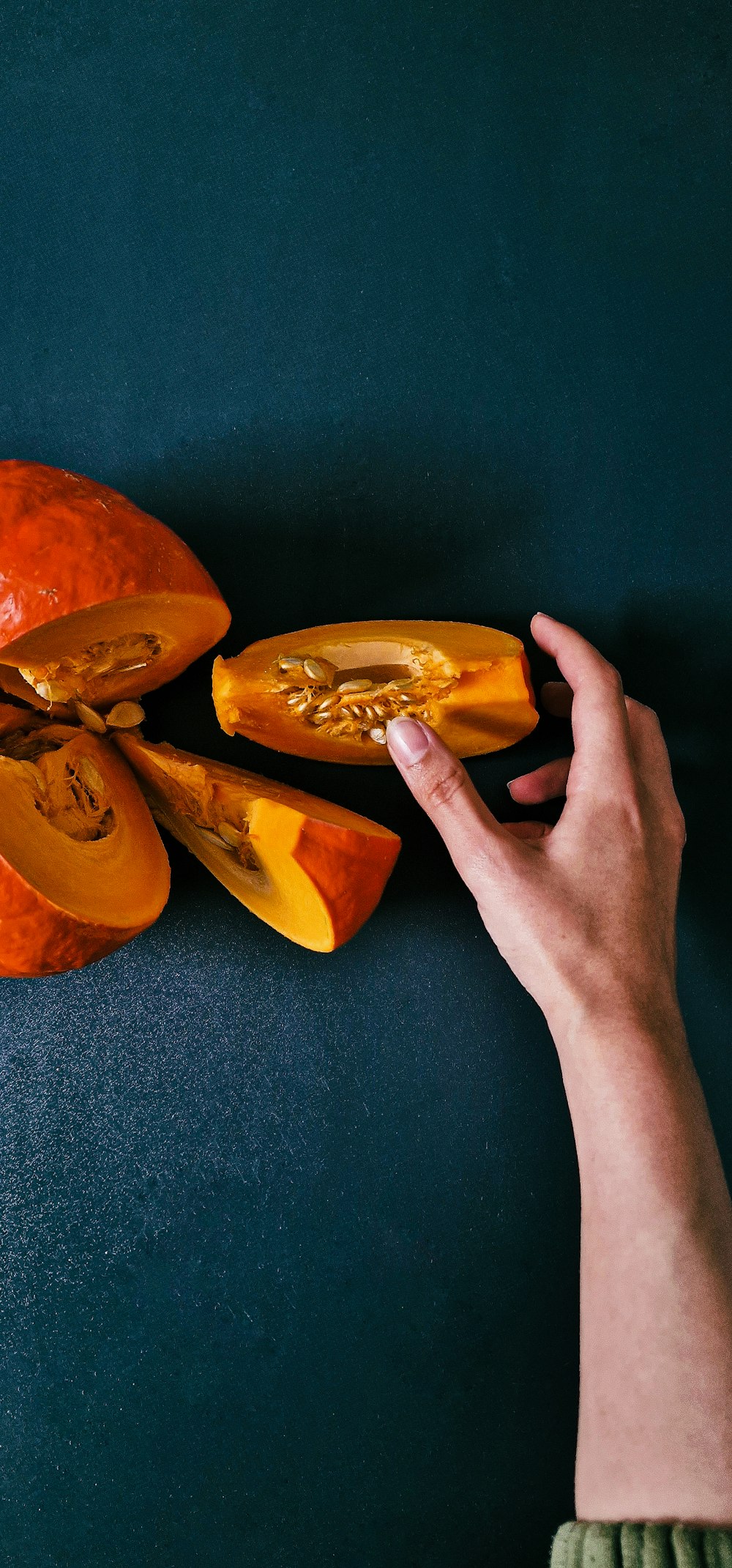 a hand holding a peeled orange