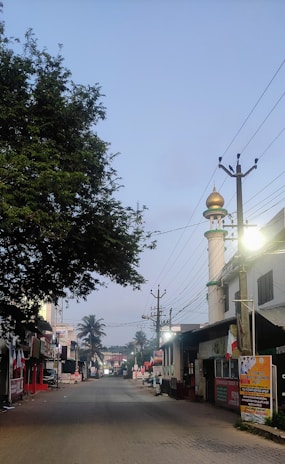 A serene street scene in Madinah with locals greeting each other warmly under soft morning light.