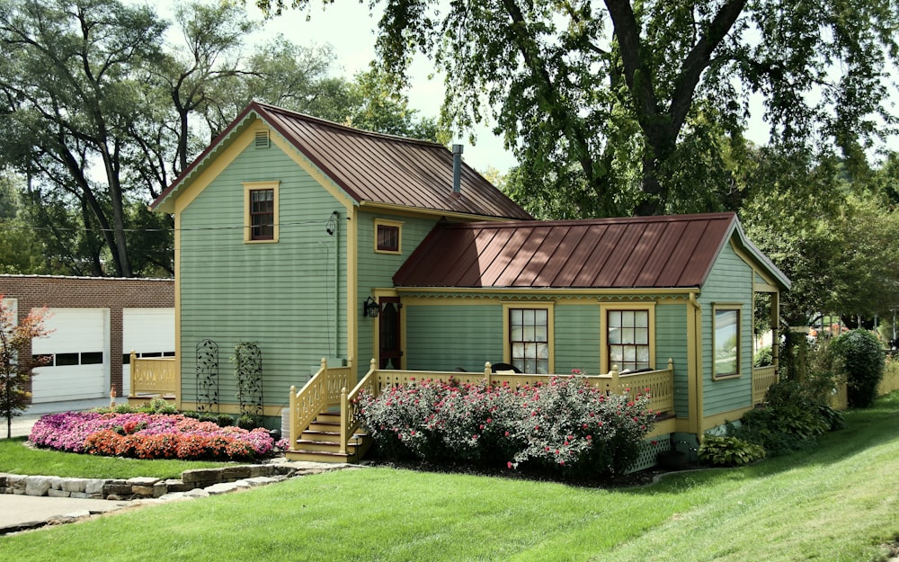 a green house with a red roof