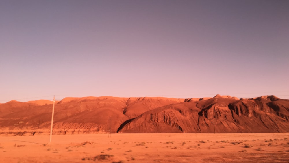 a desert landscape with a few tall mountains