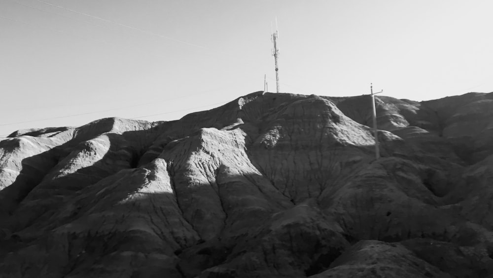 a rocky mountain with a cross on top