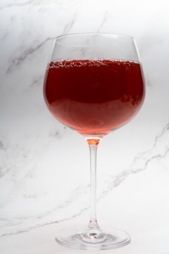 Winemaker inspecting the clarity of freshly pressed grape juice.
