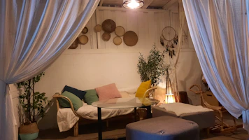 An intimate nook styled with afrobohemian textiles, plants, and handcrafted decor pieces.