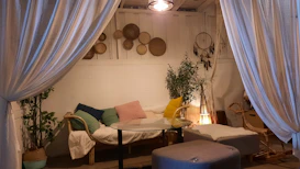 An intimate nook styled with afrobohemian textiles, plants, and handcrafted decor pieces.