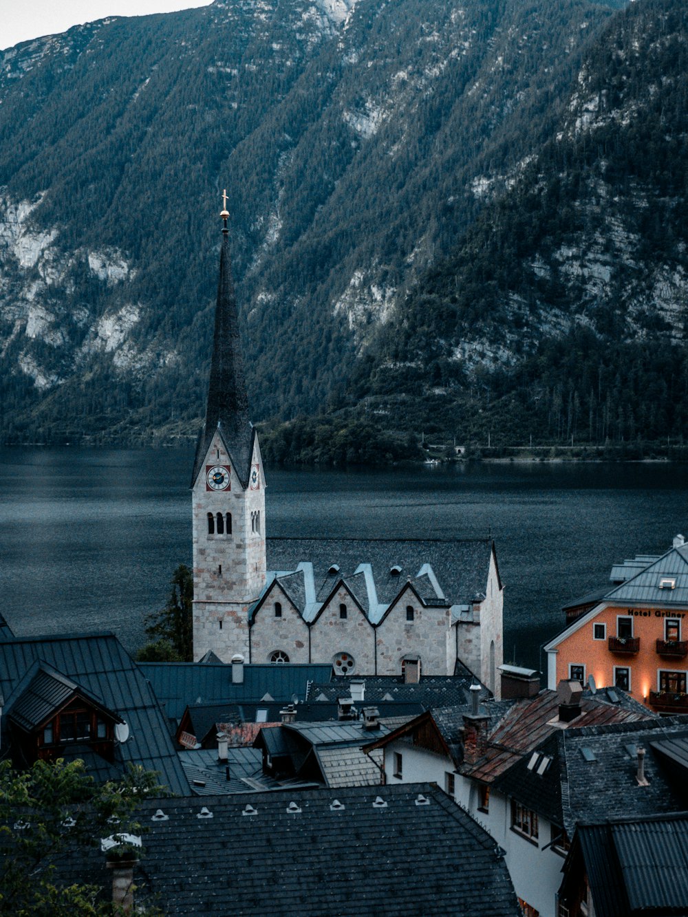 a building with a tower by a body of water