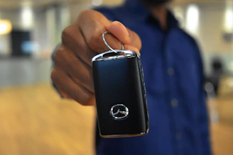 Buyer receiving keys to a new car after using a car buying service