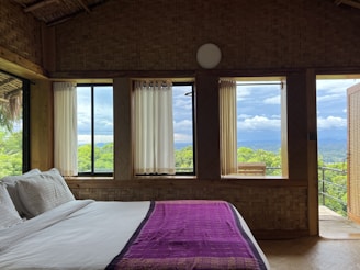 a bedroom with a large window