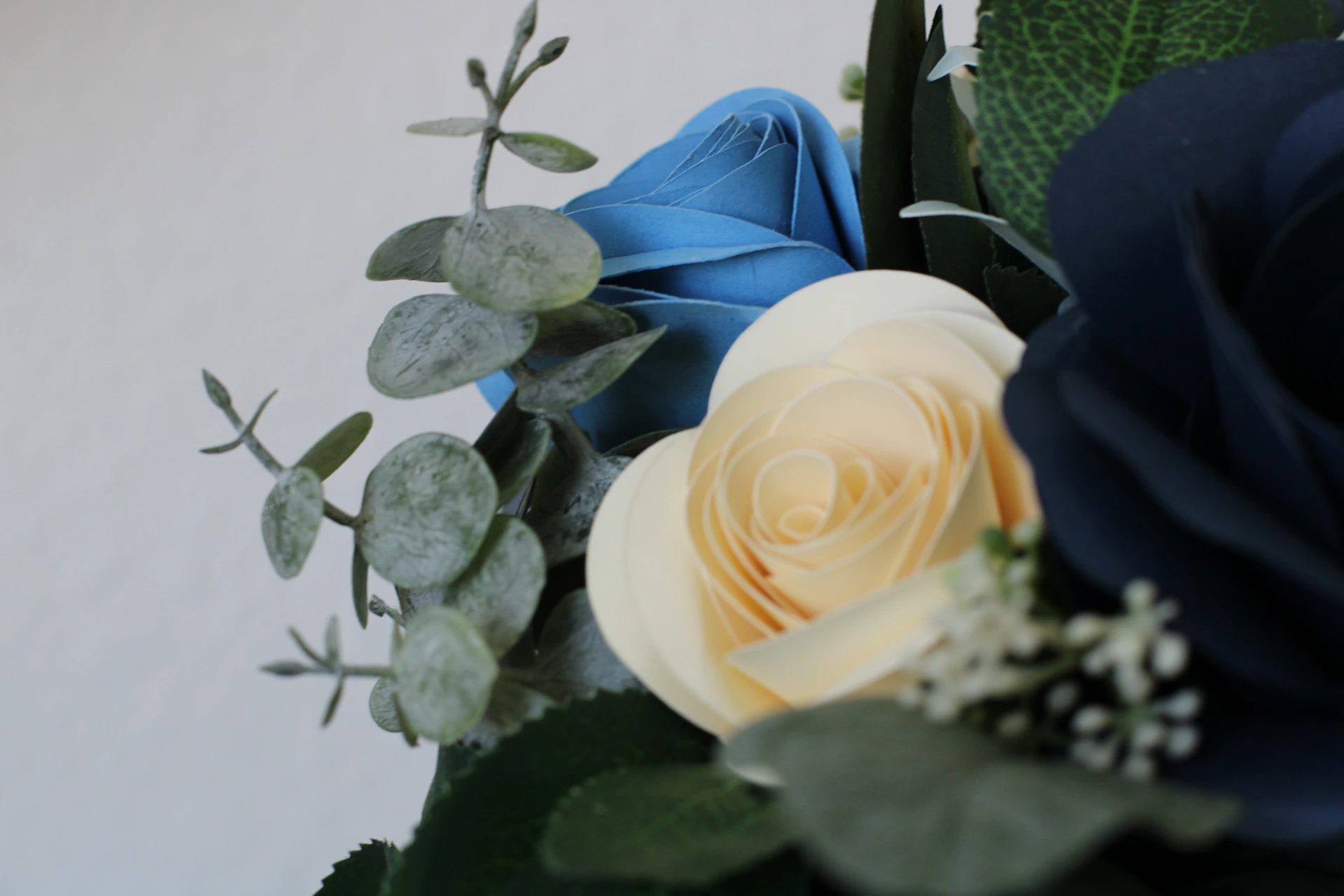 Close-up of a beautifully crafted condolence flower board with warm blue hues and delicate floral details.