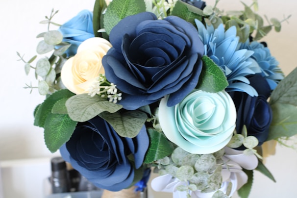 An elegant paper flower wreath featuring a mix of bold and subtle hues, perfect for home decor.