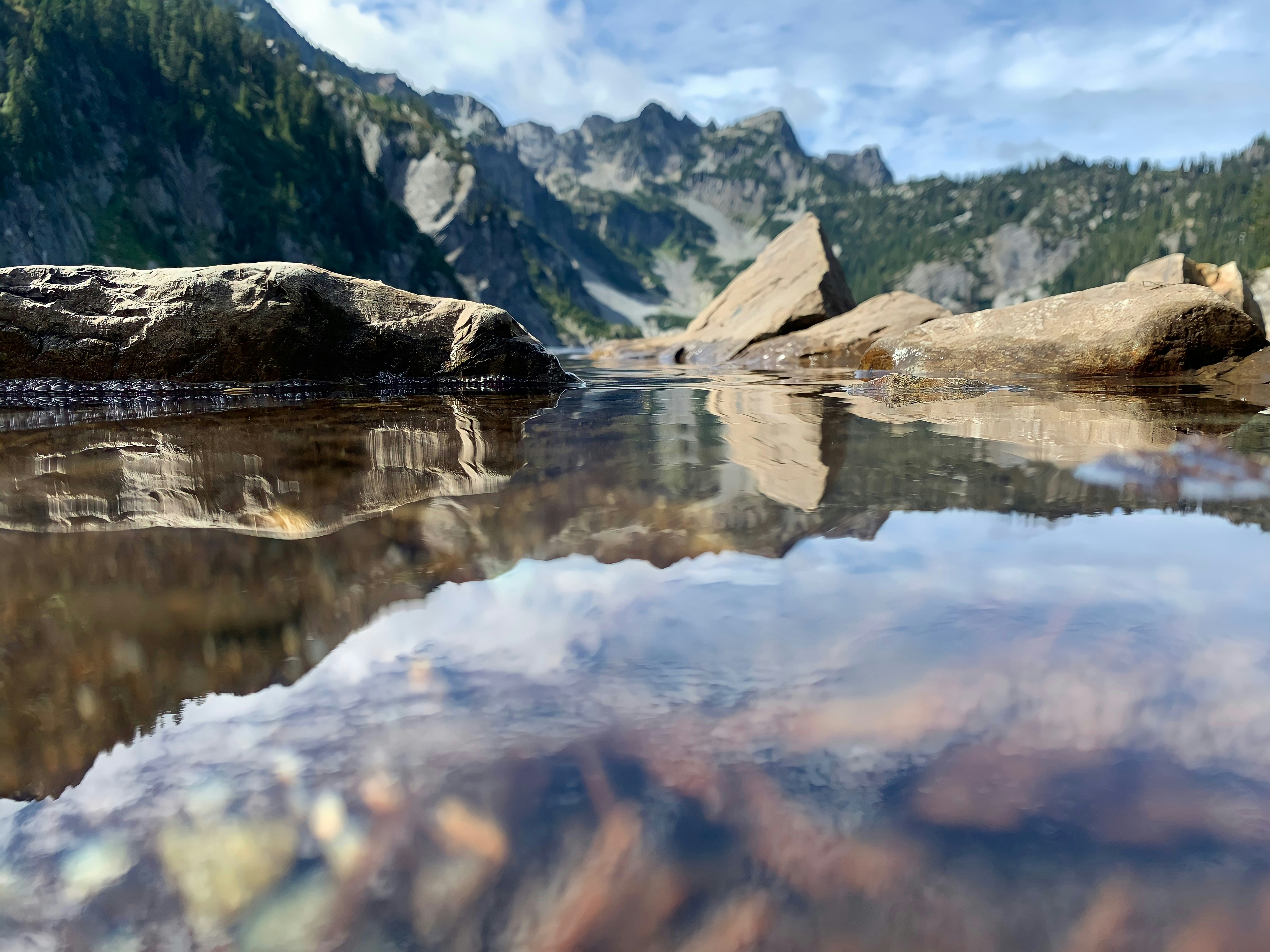 a body of water with mountains in the background
