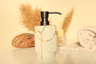 a glass vase with a gold chain