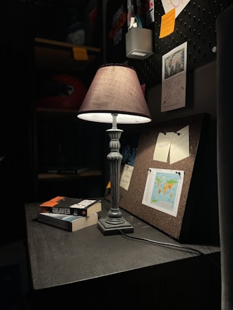 A calm study space with soft lighting and open books on a wooden desk.