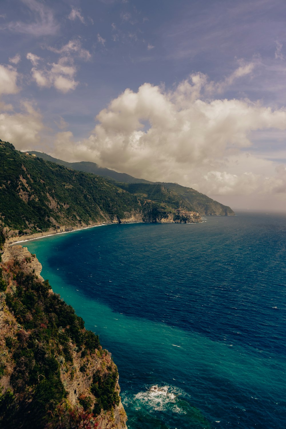 a body of water with hills and trees around it