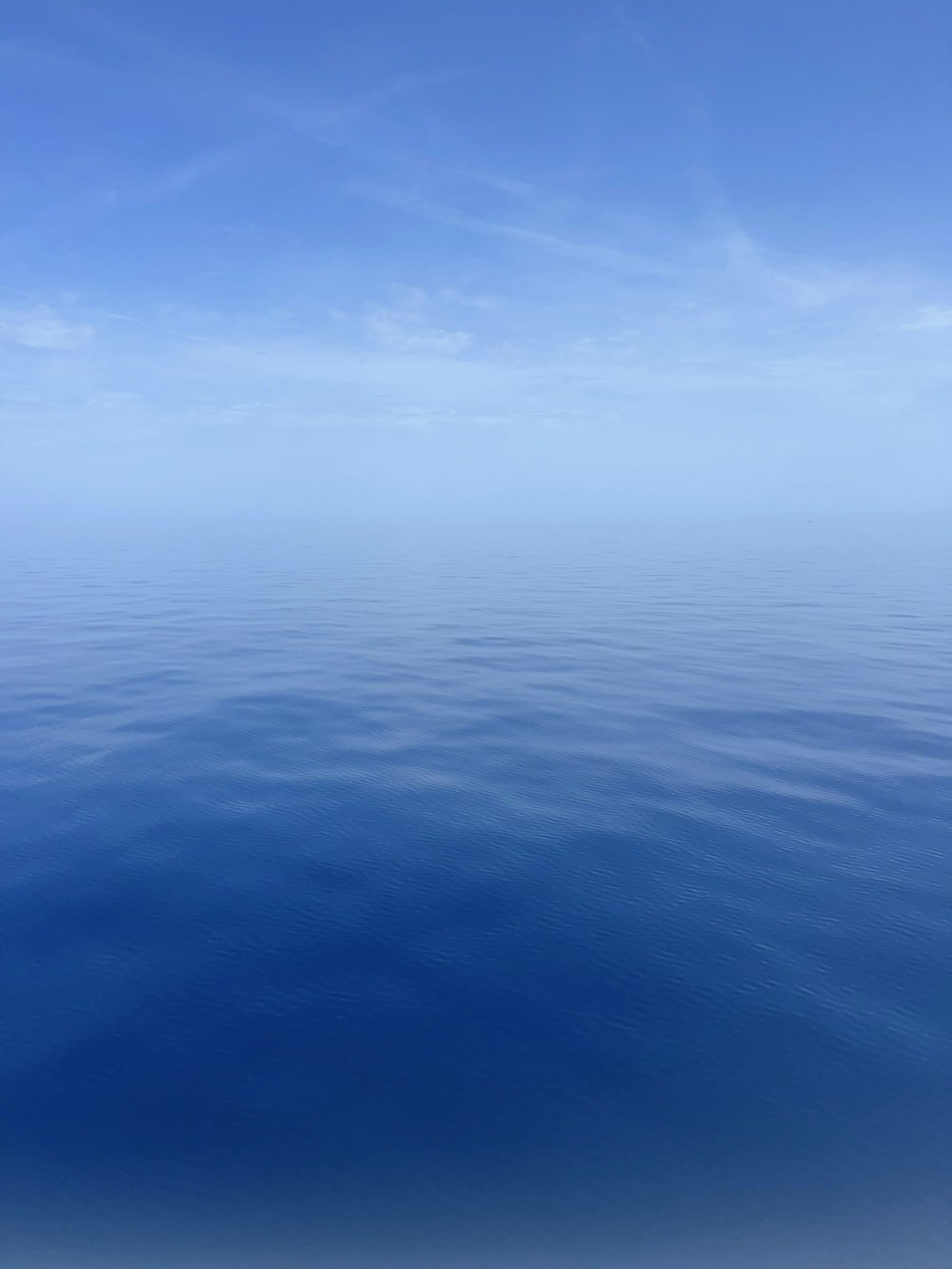 a body of water with a blue sky above