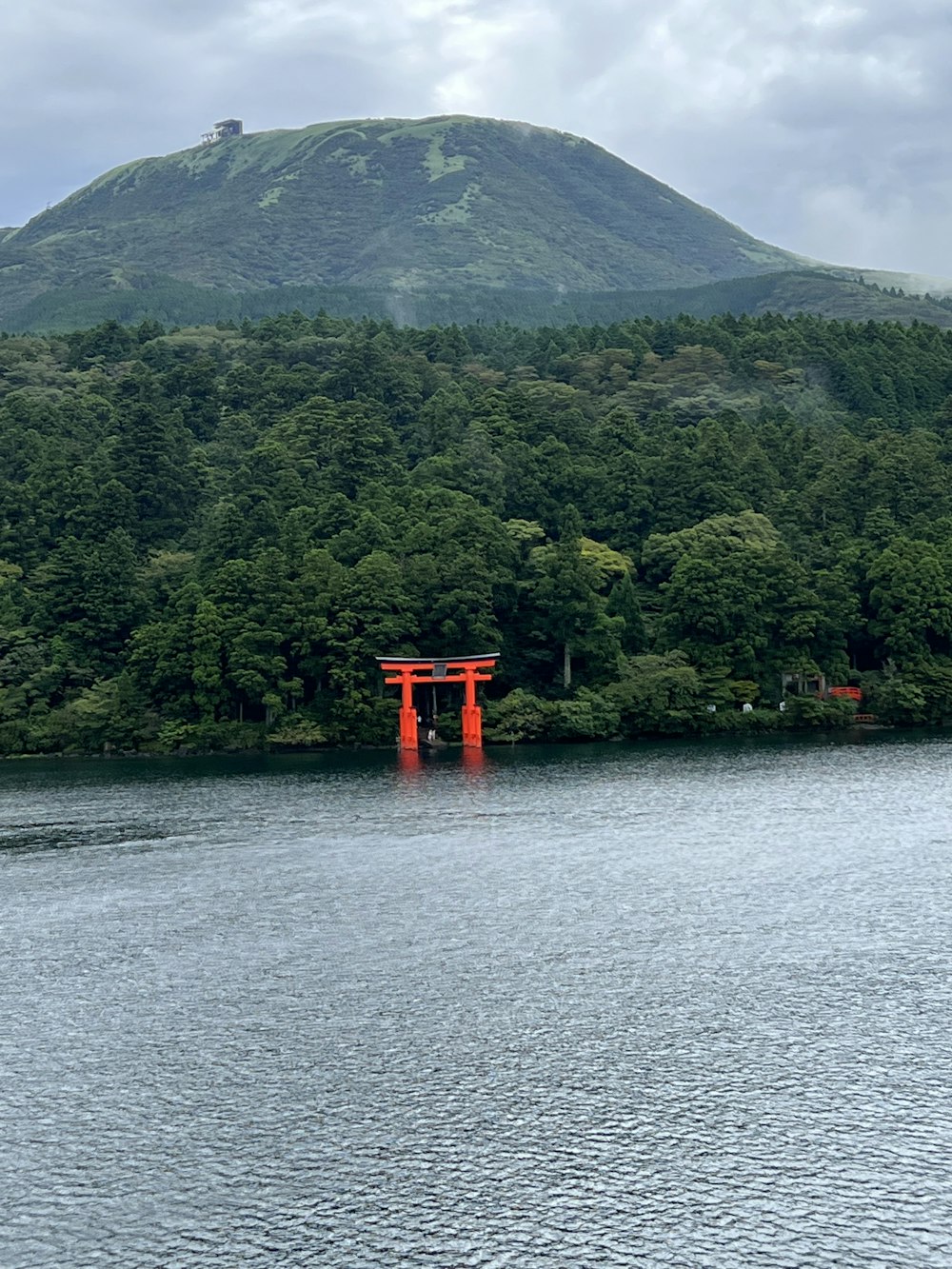 a red structure in the middle of a lake