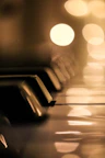 A close-up of piano keys with a shallow depth of field and blurred background