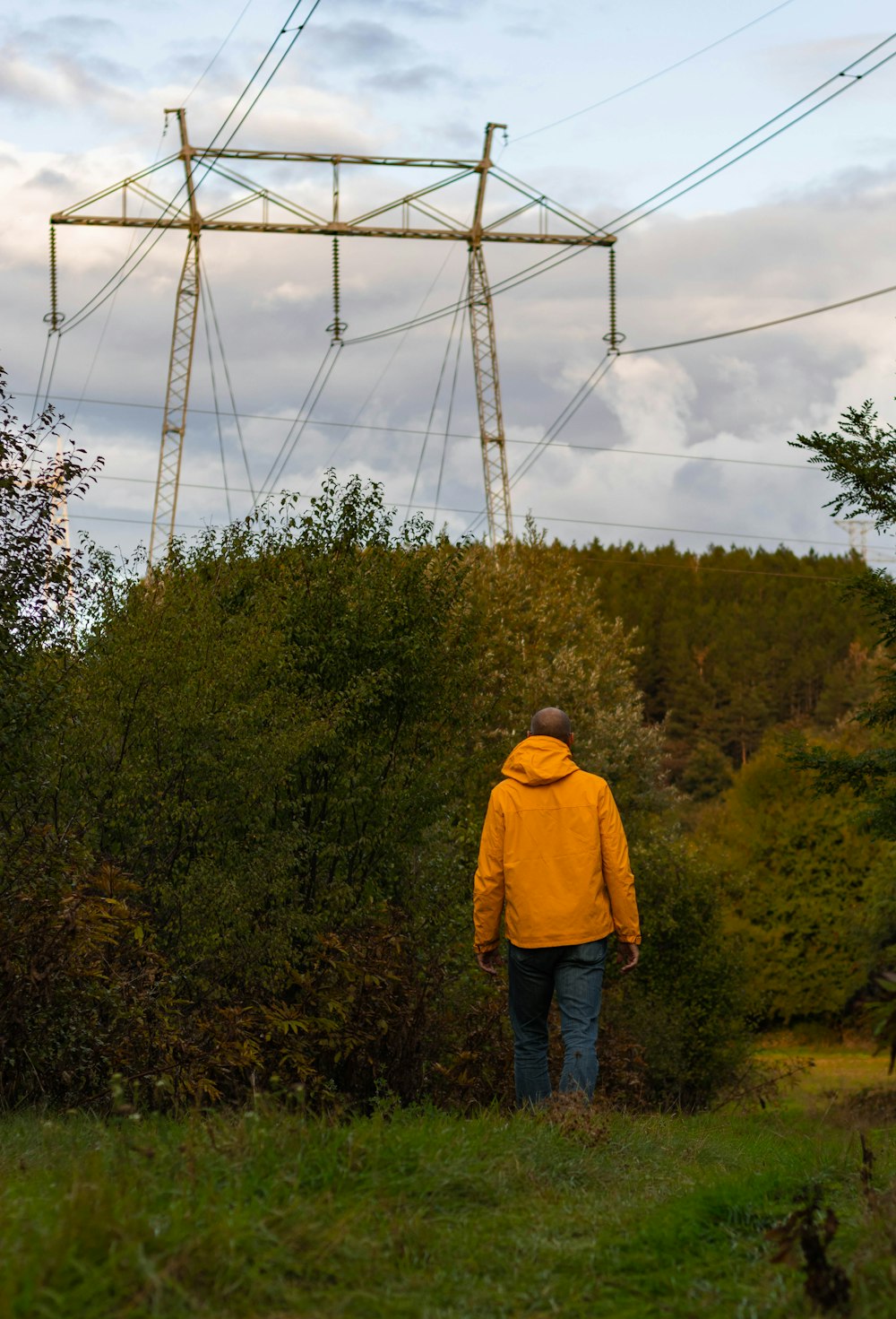 a man standing in front of a power line