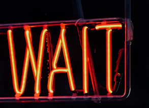 a neon sign with red lights