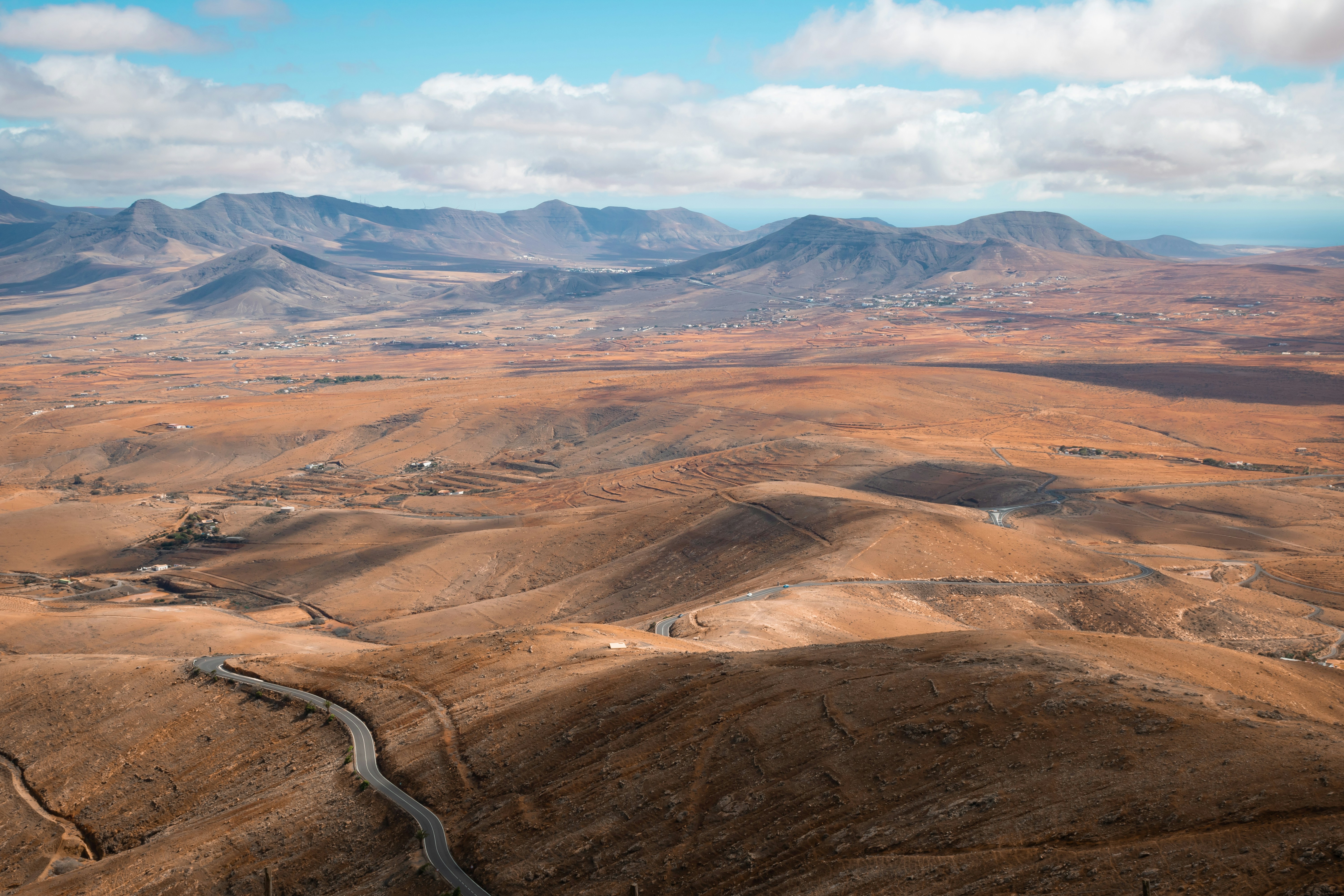 a landscape with hills and a road