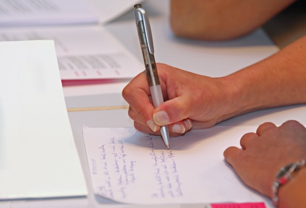 a few people writing on paper