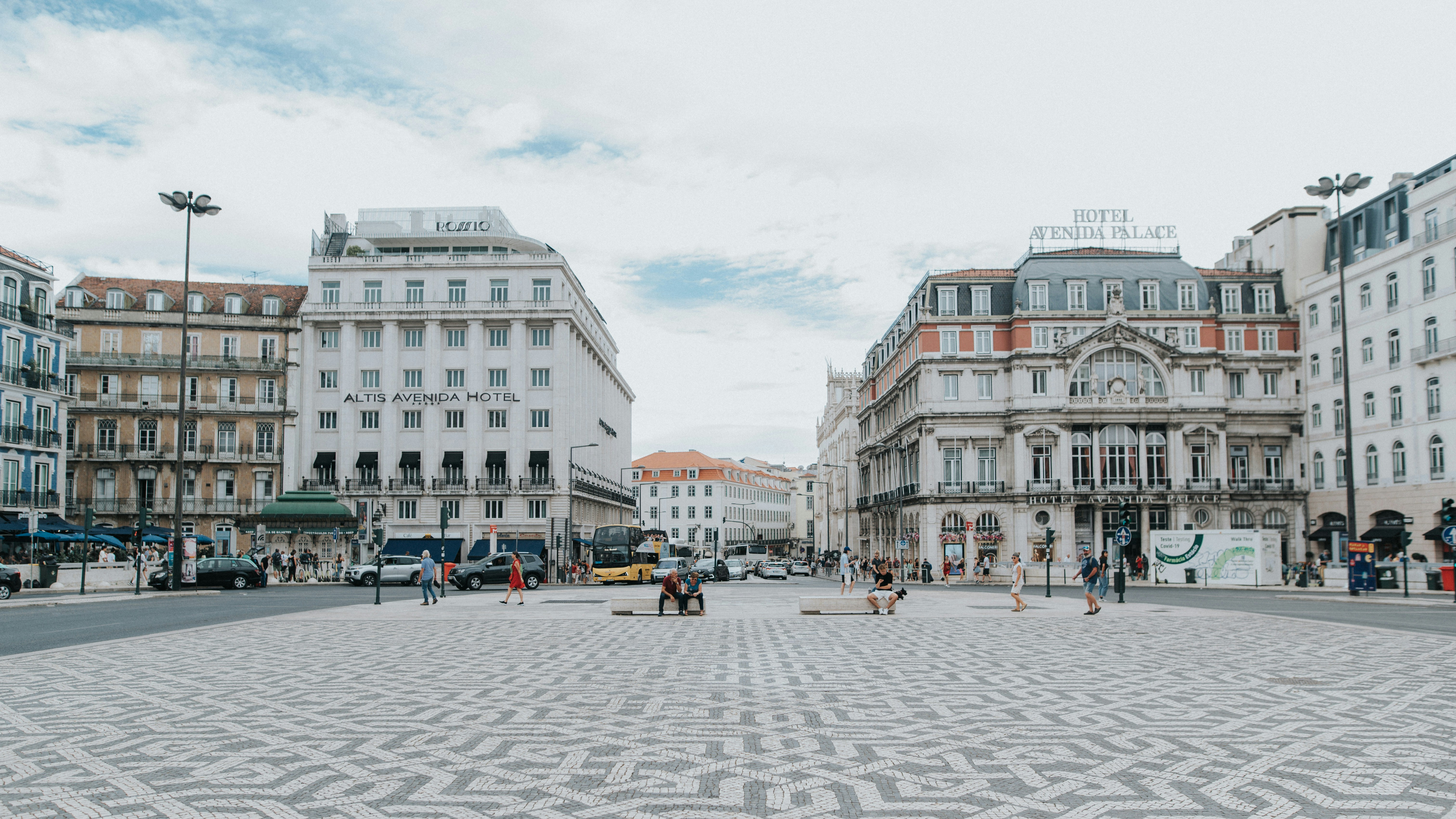 a group of people walking around a city square
