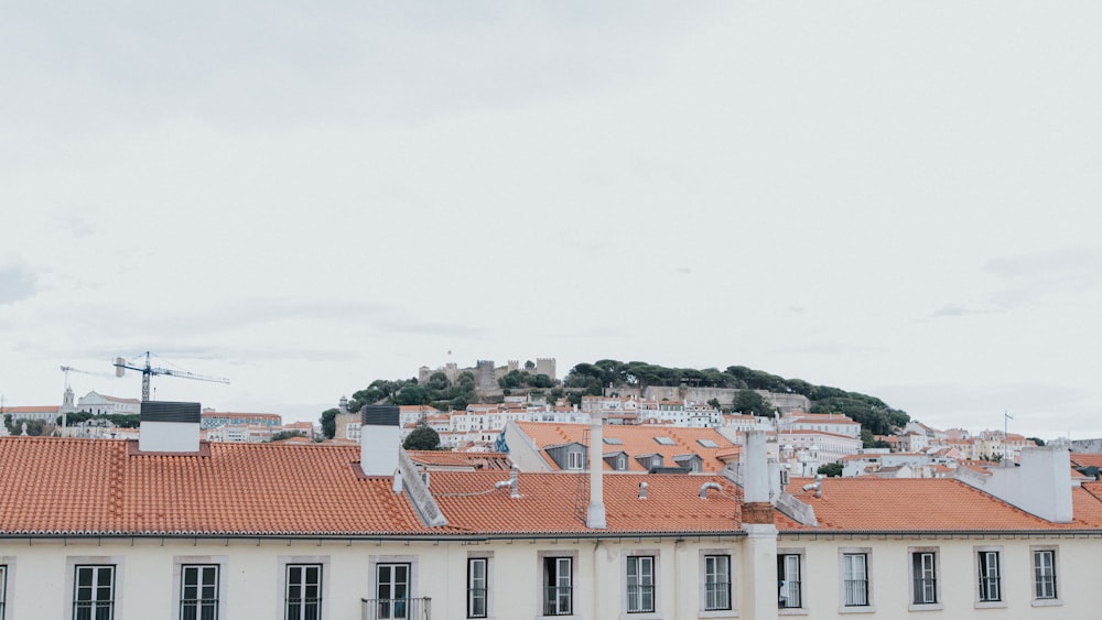 a rooftop of a building with a hill in the background