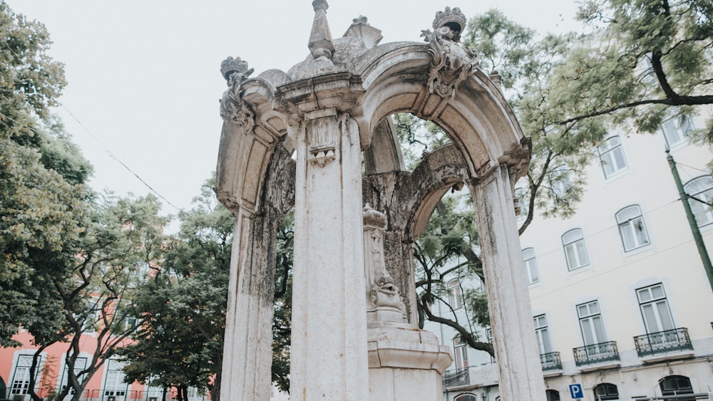 a building with pillars and trees