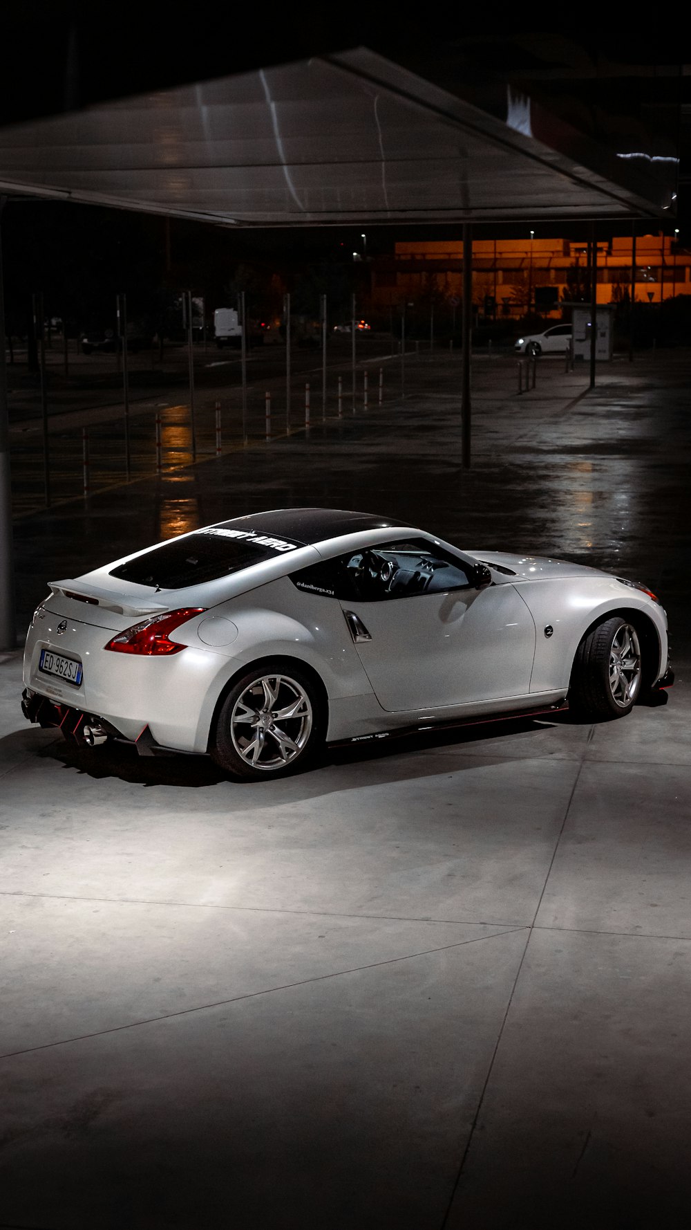 a white sports car parked in a parking garage