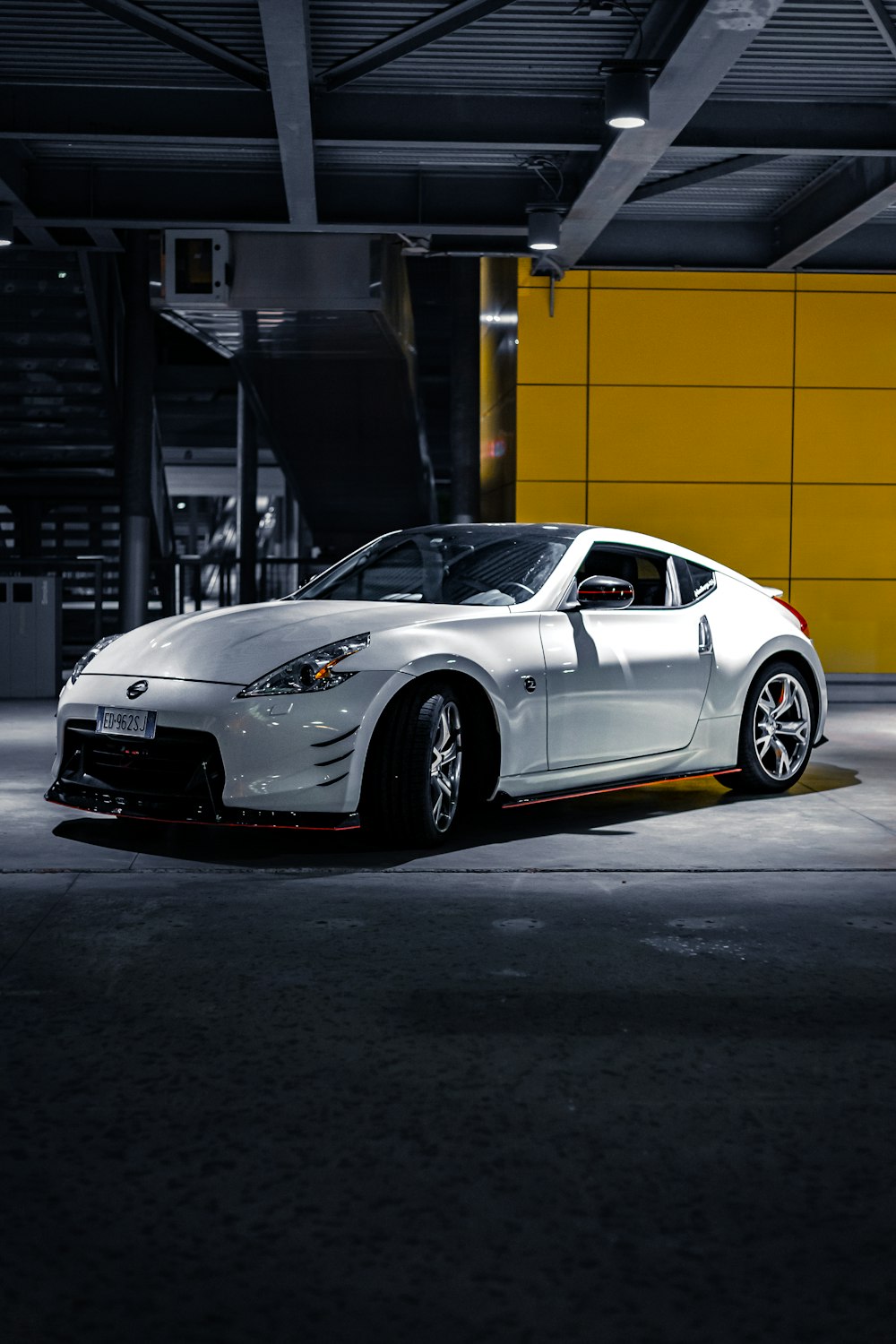 a white sports car parked in a garage