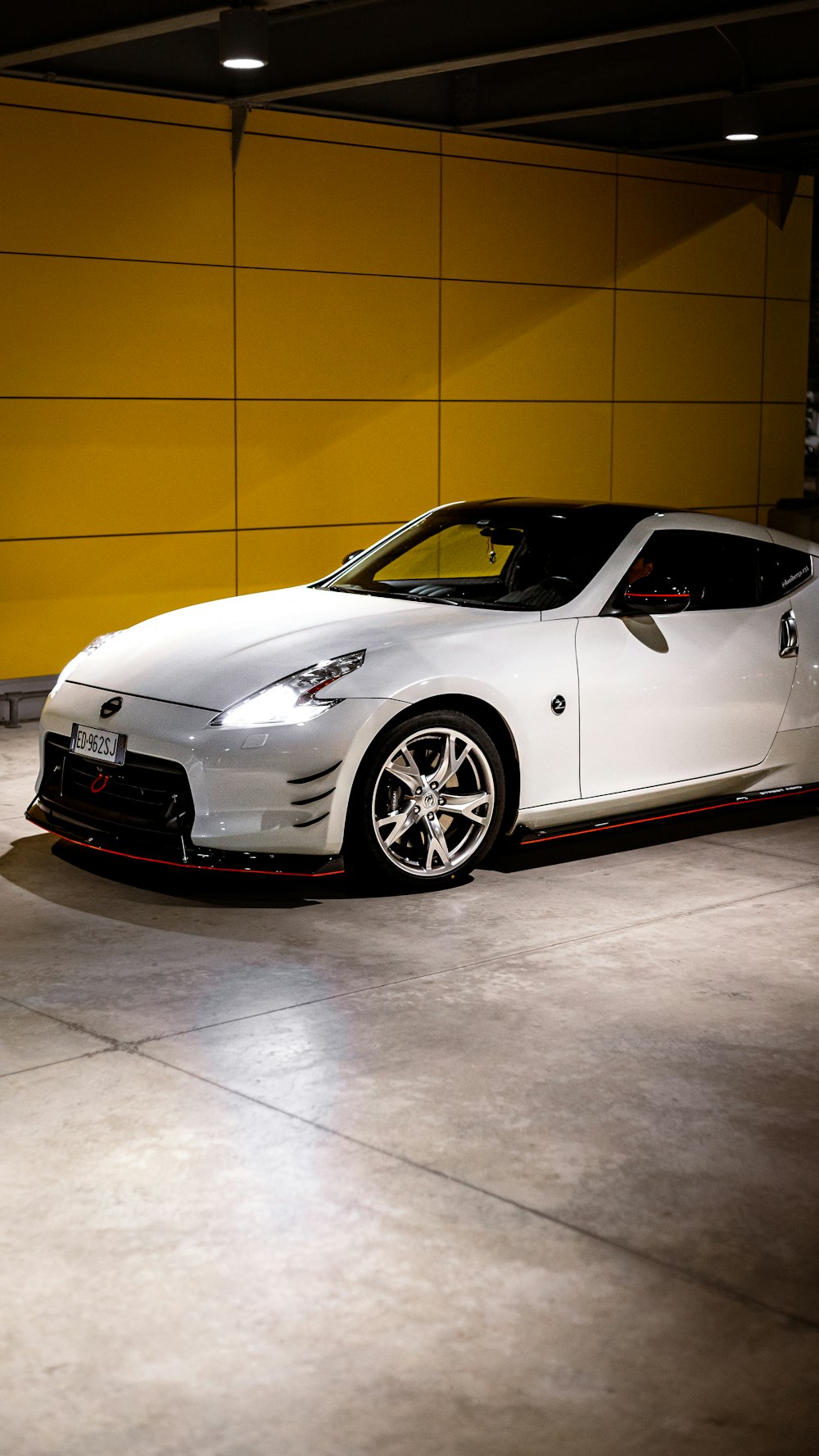 a white sports car parked in a garage