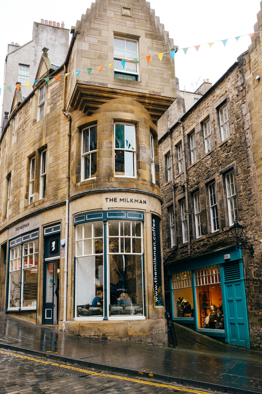 a building with windows and a person sitting in a window