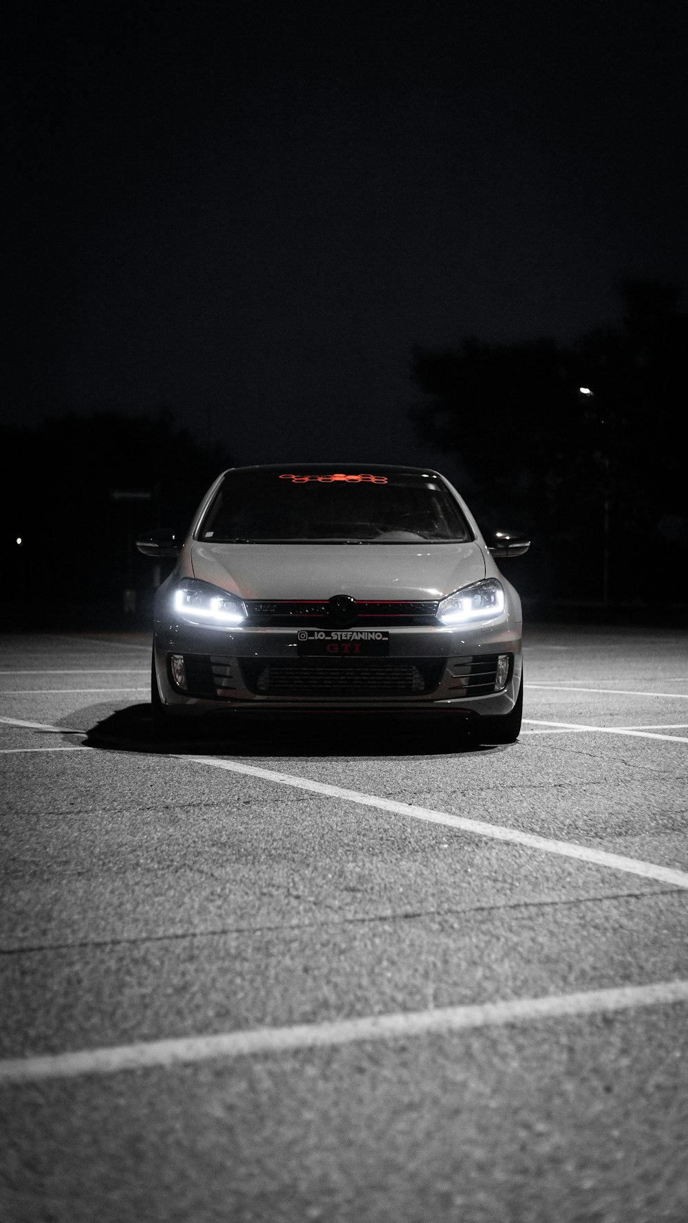 a car parked in a parking lot at night