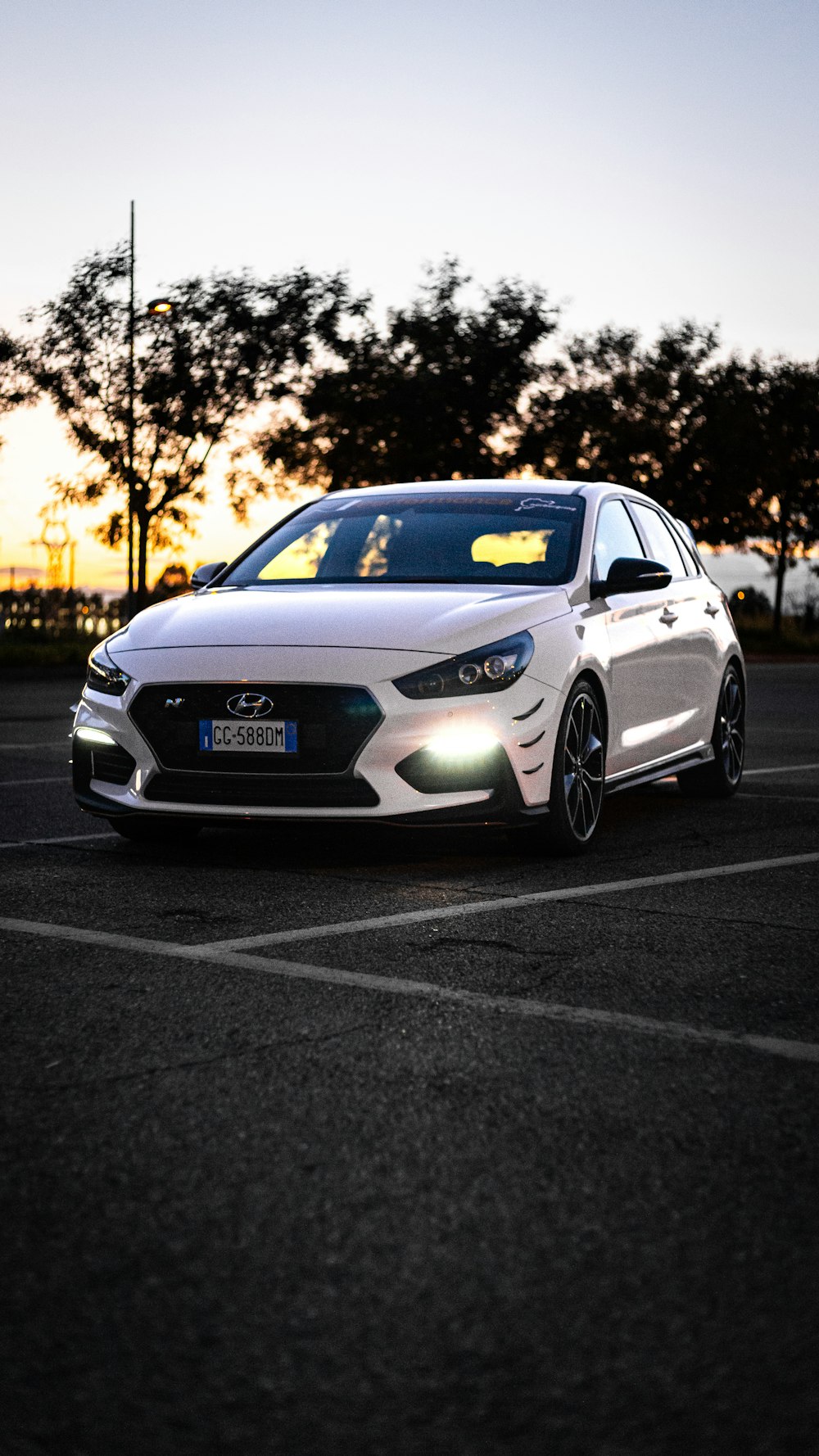 a white car with its headlights on