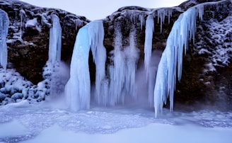 a group of waterfalls in a snowy place