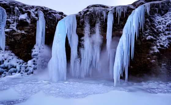 a group of waterfalls in a snowy place