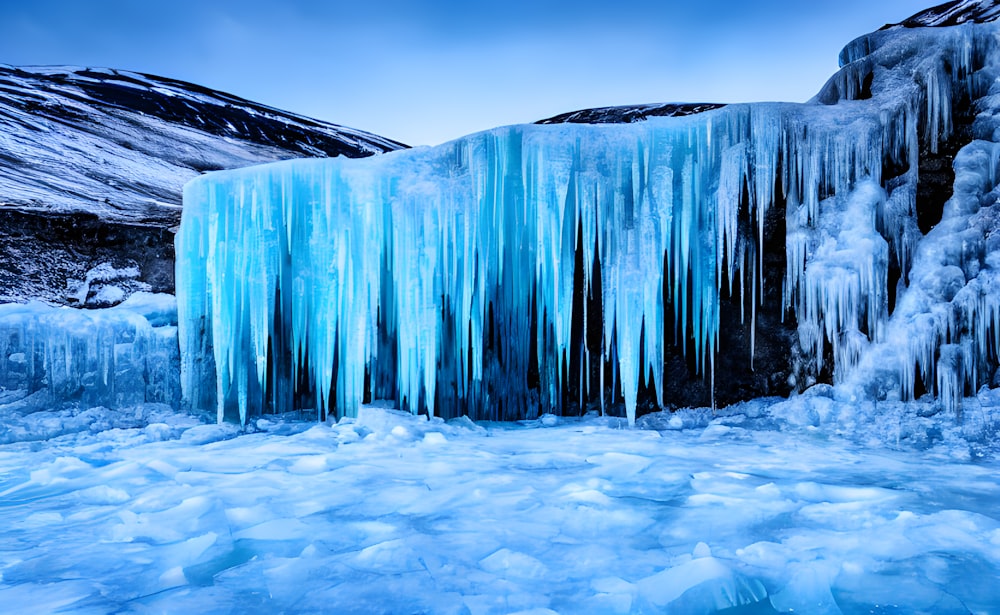 a large waterfall in a snowy place