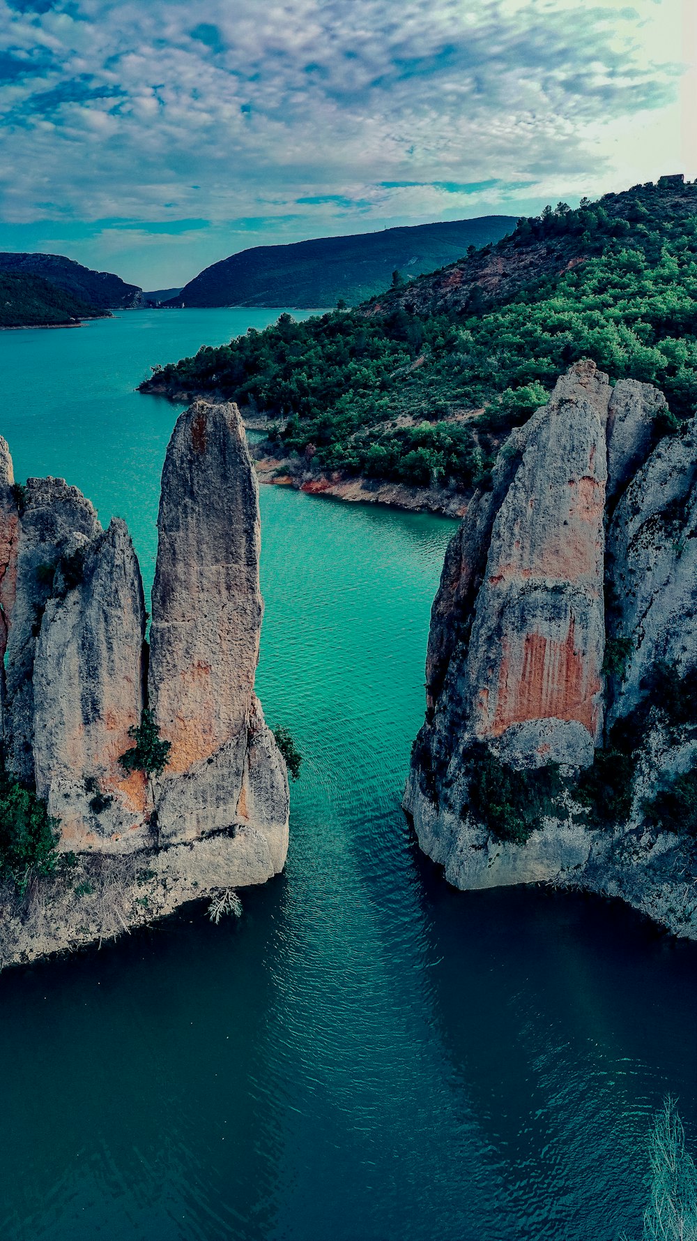 a cliff with a body of water below