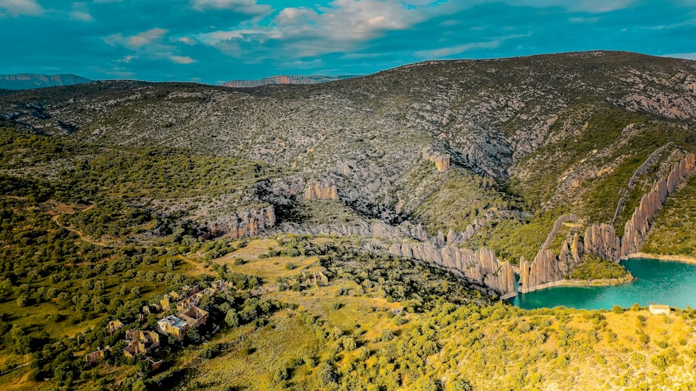 a landscape with a body of water and a rocky cliff