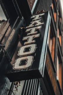 Close-up of a bold, colorful sign with intricate lettering on a storefront