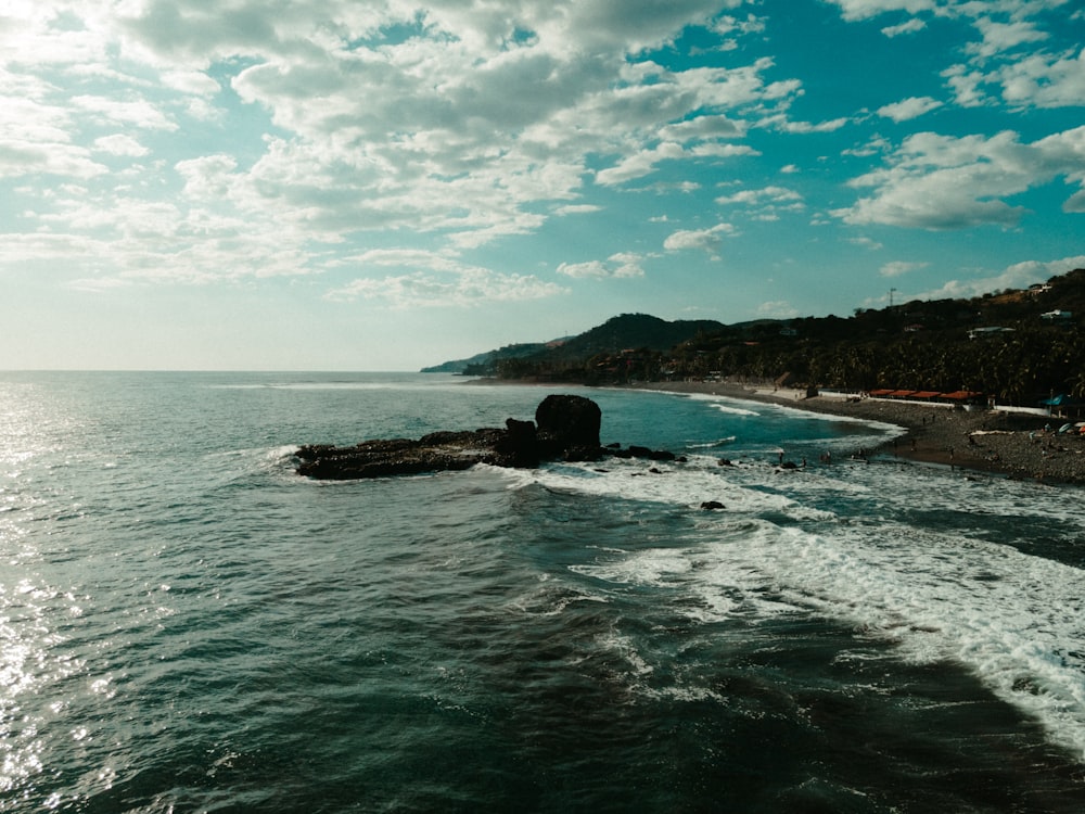 a beach with rocks and a body of water