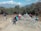 A group of hikers resting on a scenic overlook with vast mountain views.