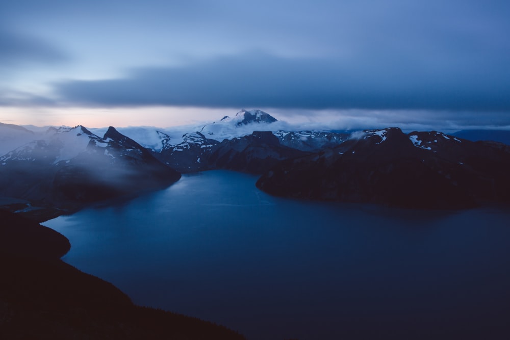 a body of water with mountains in the background