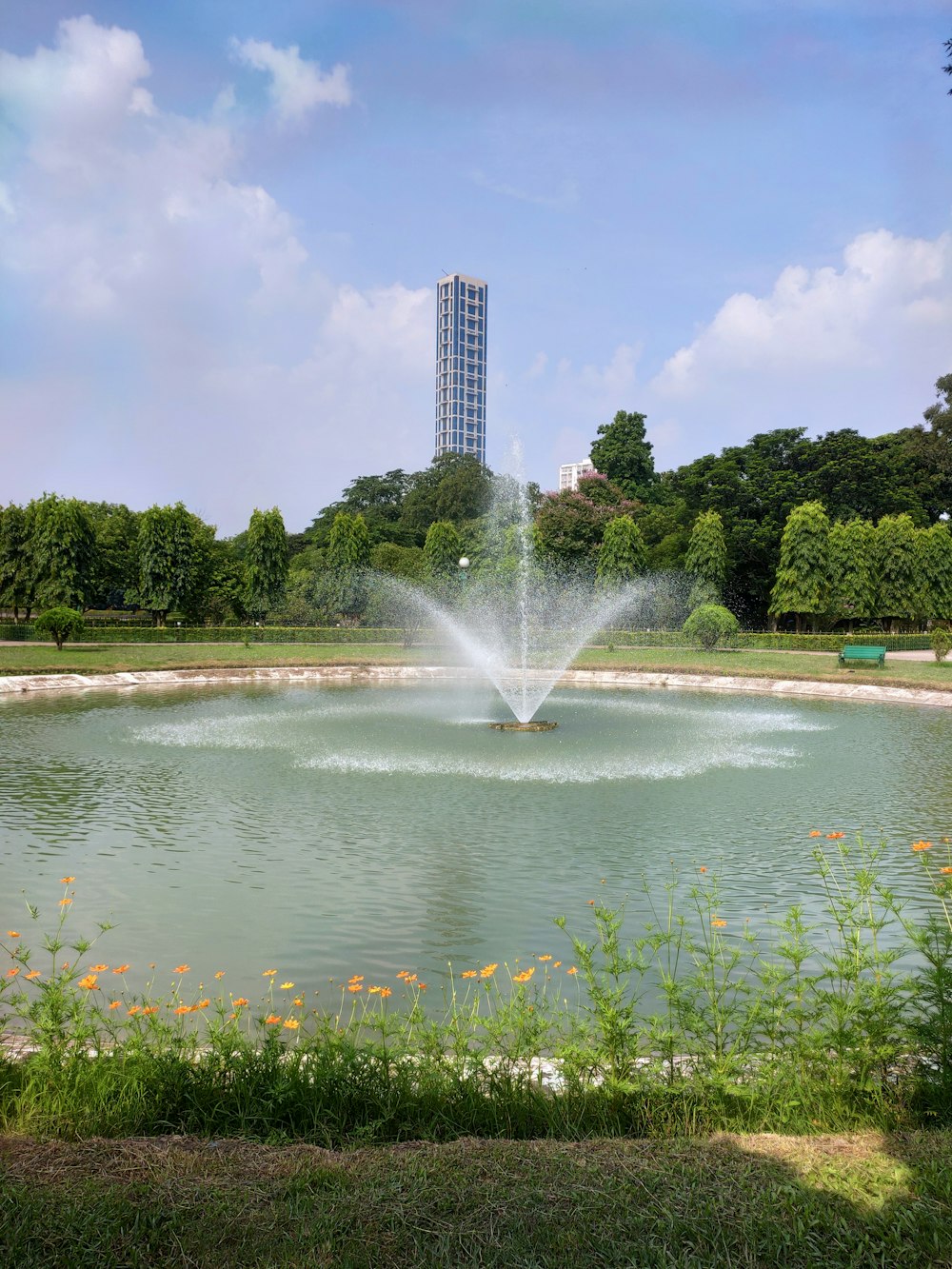 a fountain in front of a body of water