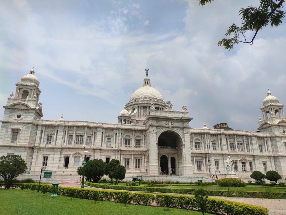 a large stone statue in front of Victoria Memorial Hall