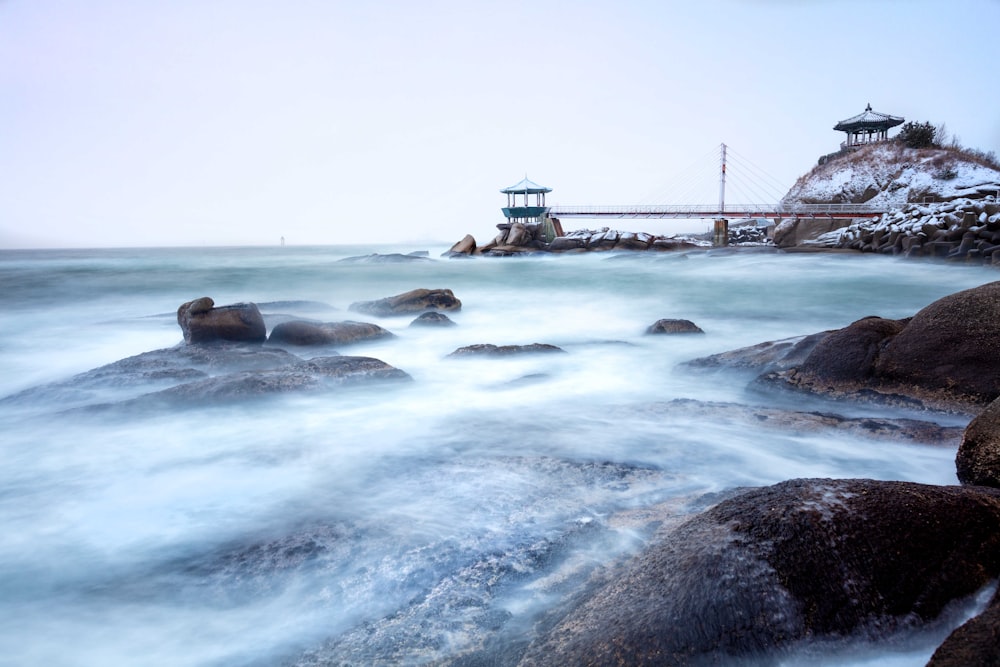 a rocky beach with a pier