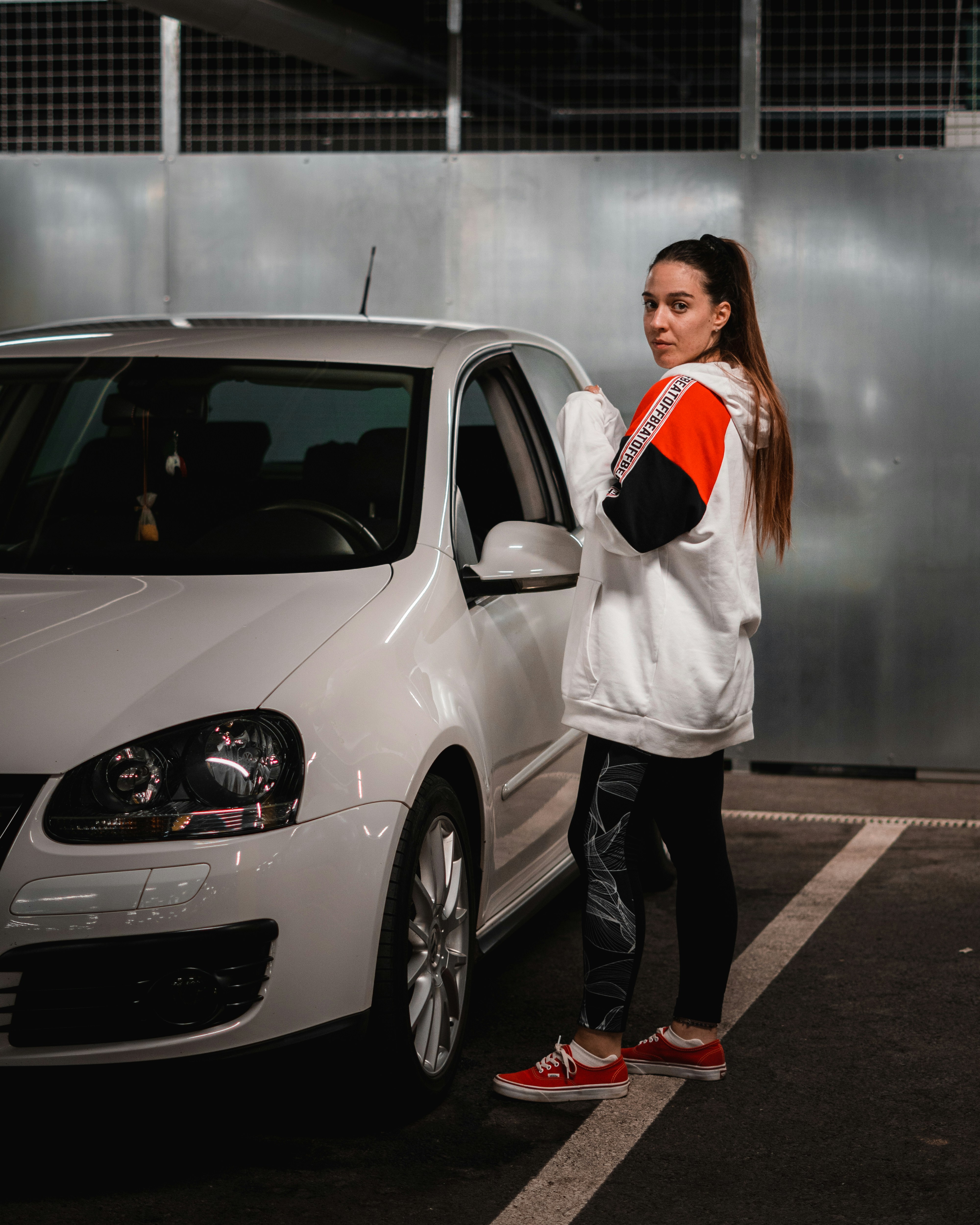 a person standing in front of a car