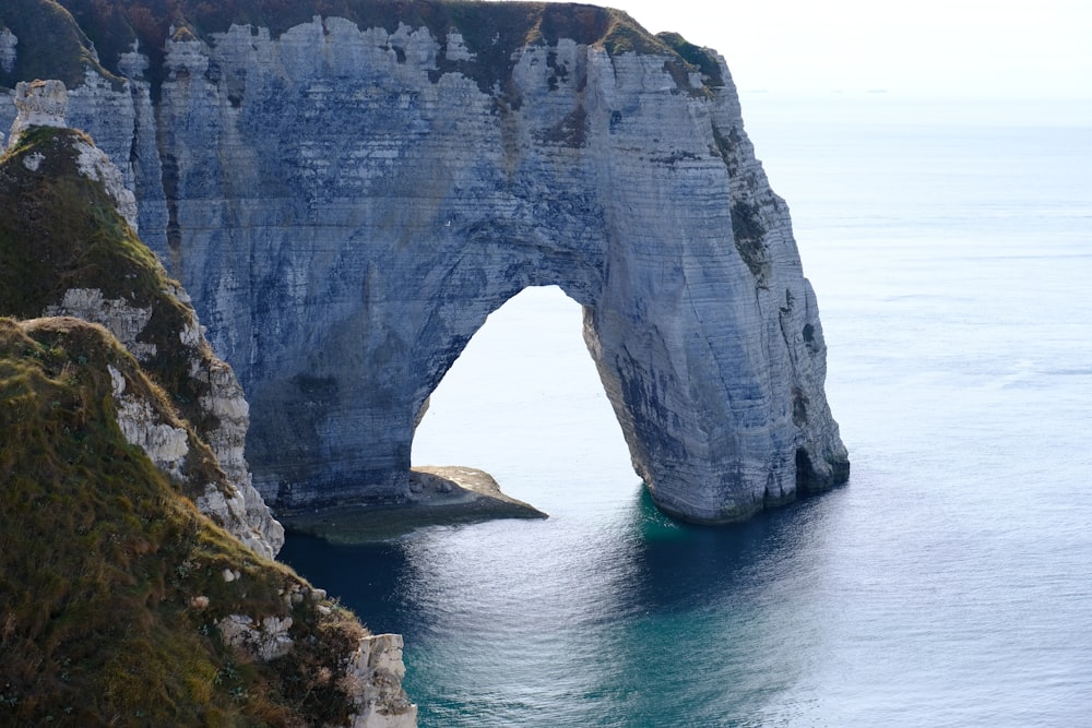 a large rock arch over water