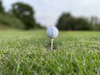A detailed shot of high-tech golf rangefinder resting on a tee box