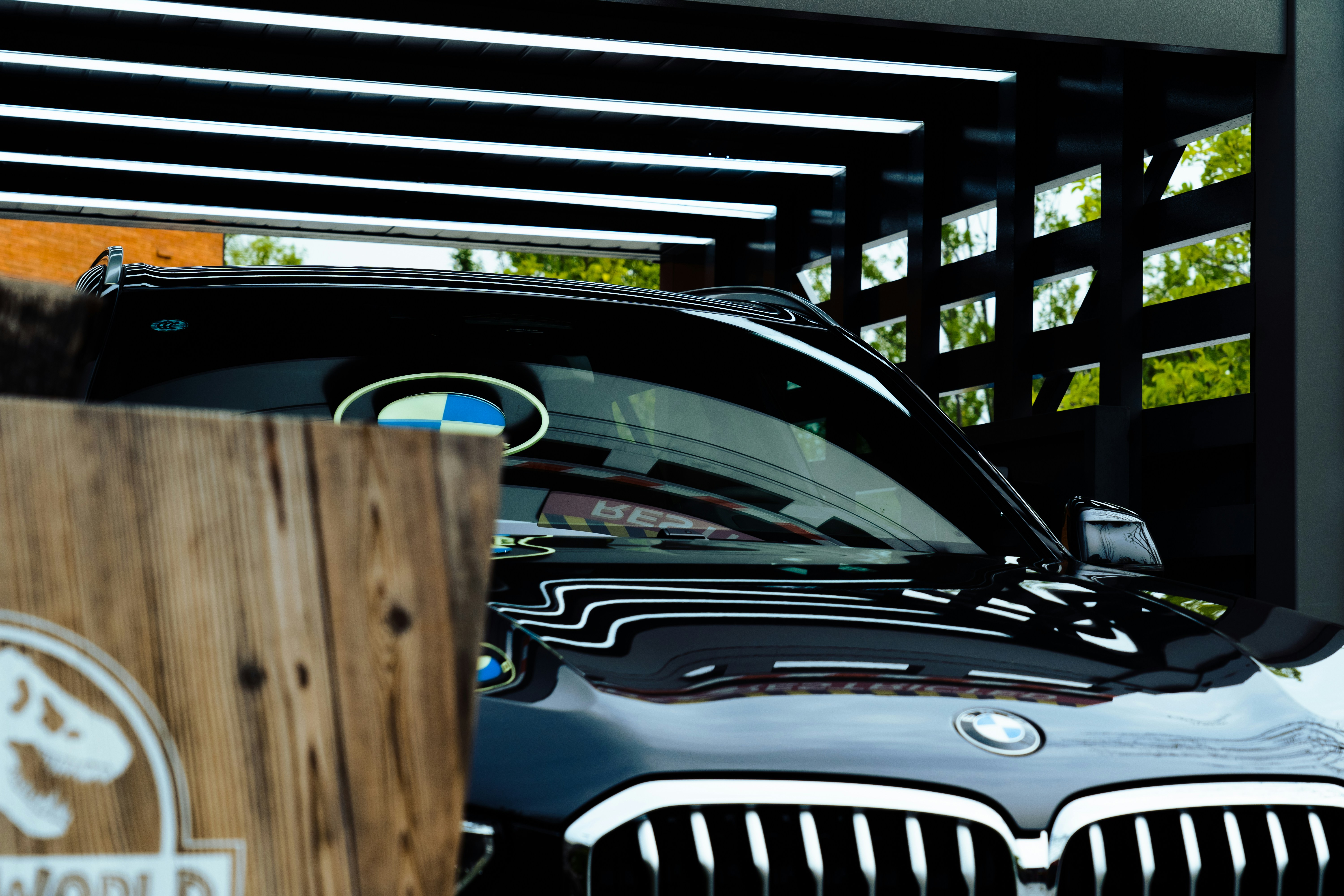 BMW i4 electric sedan parked at a modern home with a charger