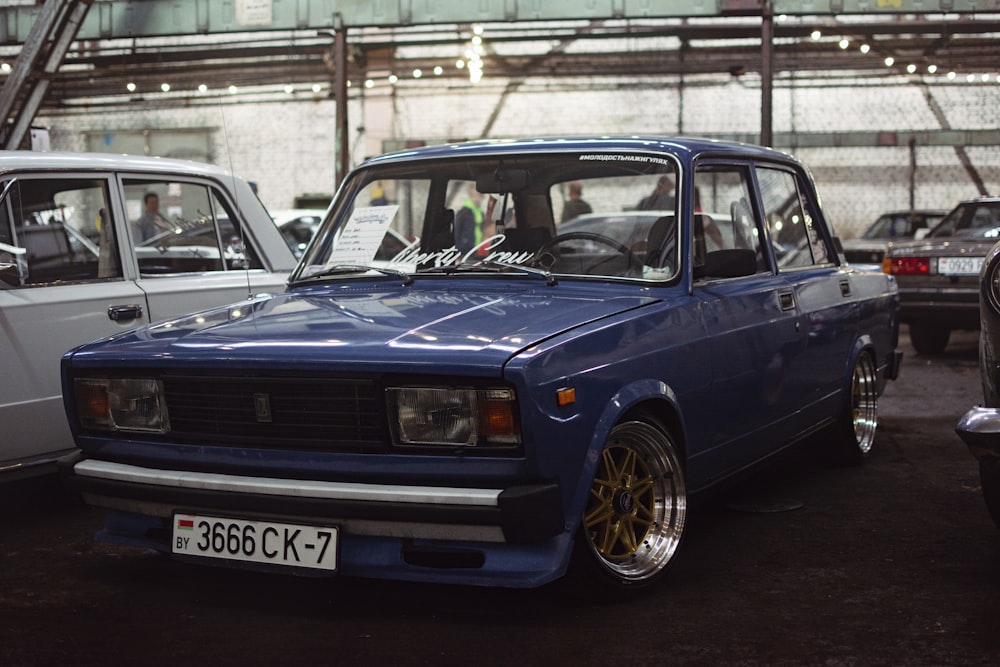 a blue car parked in a parking lot